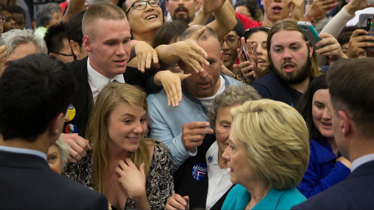 Supporters reach toward Hillary Clinton on Tuesday after her speech at UC Riverside.