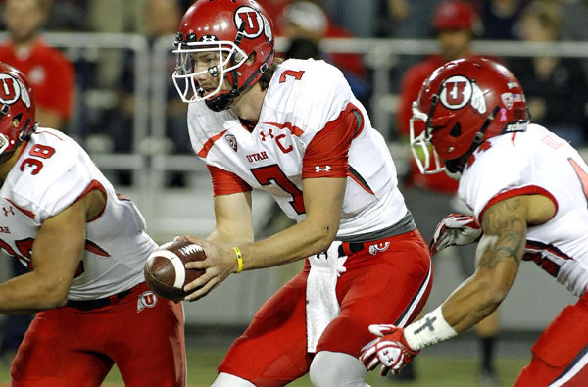 Utah quarterback Travis Wilson (7) checks the line during a read-option play against Arizona last week.