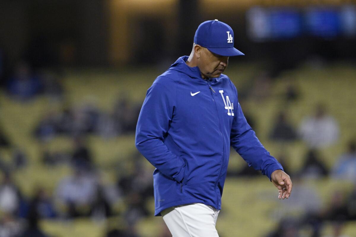 Los Angeles Dodgers manager Dave Roberts walks back to the dugout after making a pitching change.