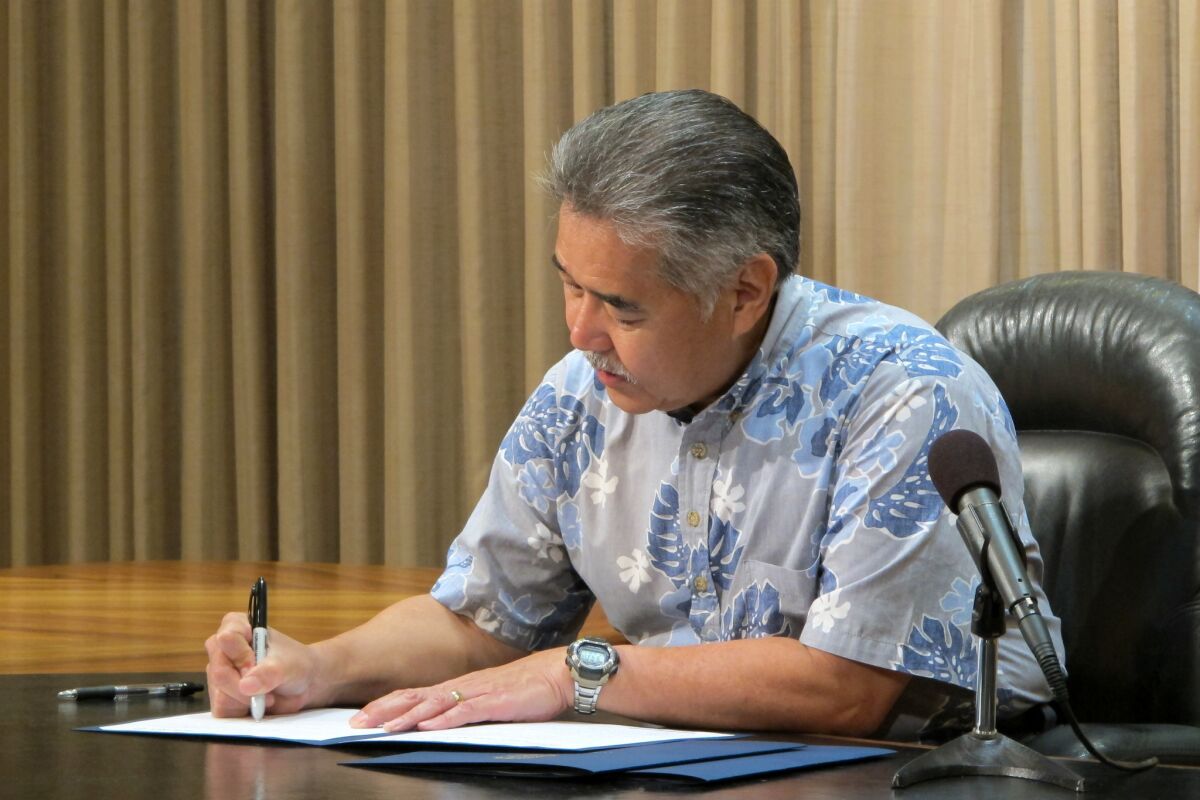 Hawaii Gov. David Ige signs bills Tuesday in Honolulu, including two on medical marijuana.