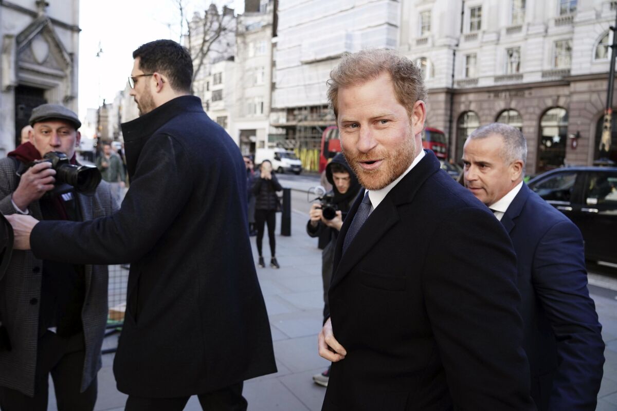 Britain's Prince Harry, center right, arrives at the Royal Courts Of Justice, in London, Monday, March 27, 2023. Prince Harry was in a London court on Monday as the lawyer for a group of British tabloids prepared to ask a judge to toss out lawsuits by the prince, Elton John and several other celebrities who allege phone tapping and other invasions of privacy. (Jordan Pettitt/PA Wire/PA via AP)