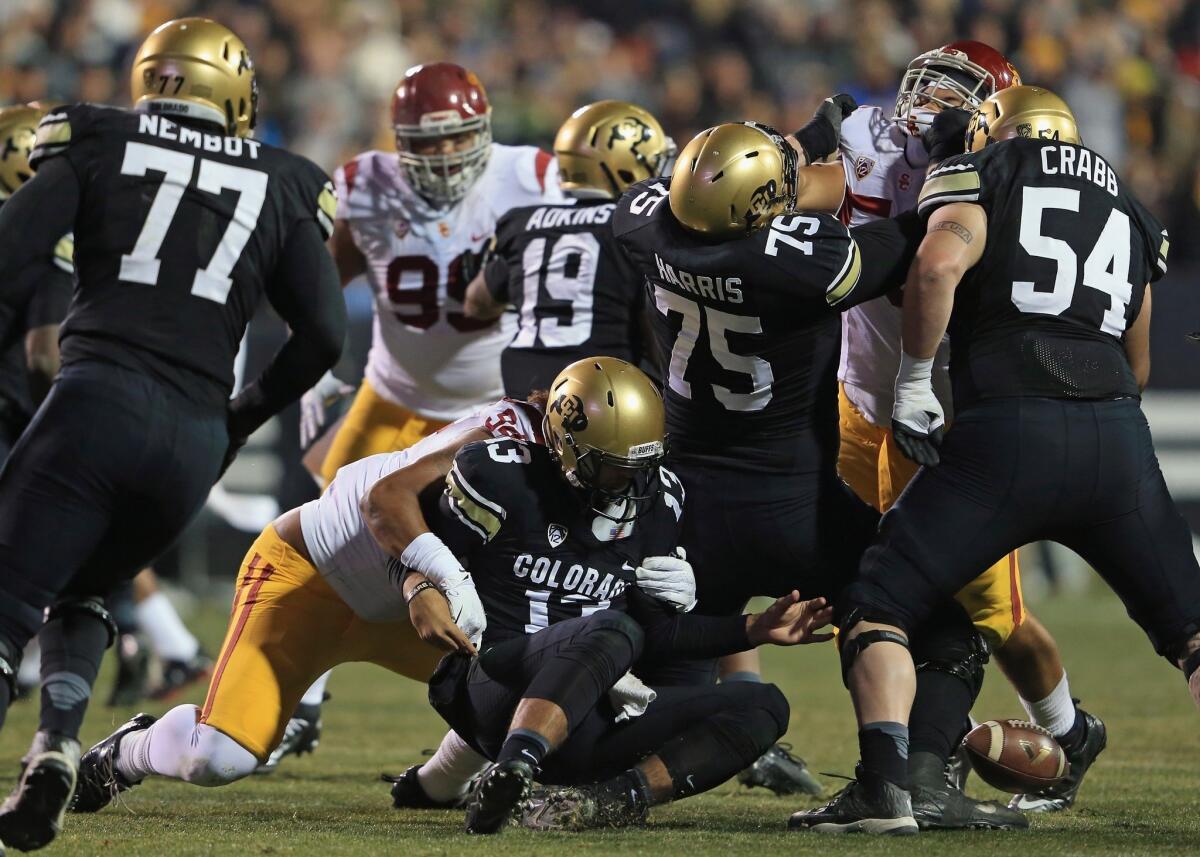 Colorado quarterback Sefo Liufau fumbles while being sacked by USC's Leonard Williams during the second quarter Saturday in Boulder.