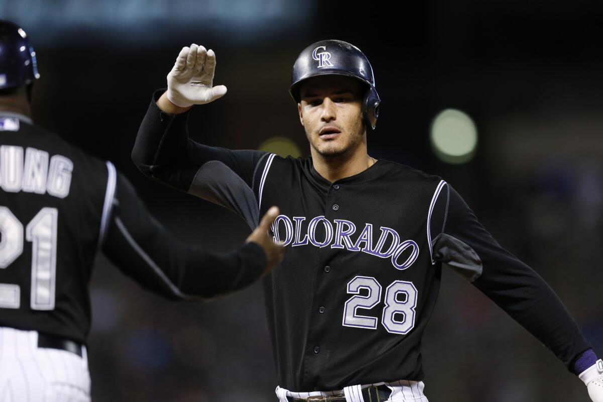 Colorado Rockies third baseman Nolan Arenado celebrates after hitting an RBI single against the San Diego Padres in the seventh inning of a game on Sept. 18.