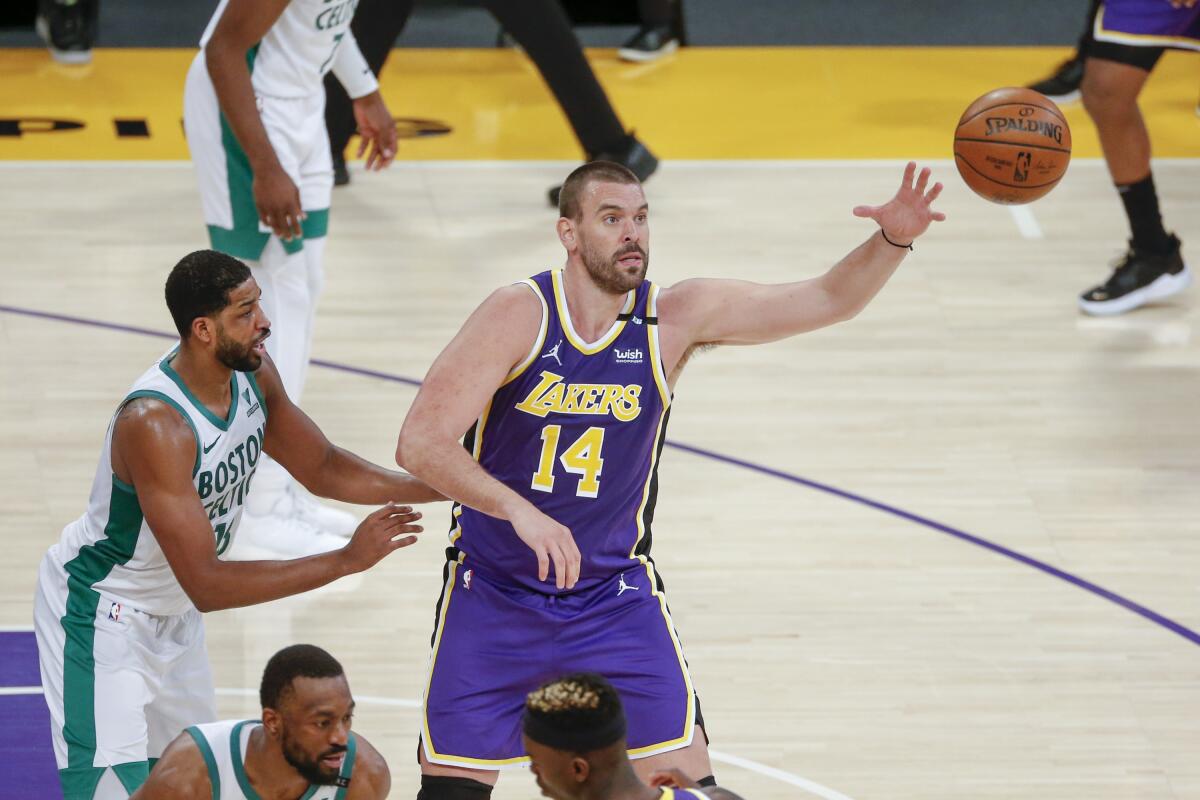 Lakers center Marc Gasol receives a pass while defended by Celtics center Tristan Thompson.