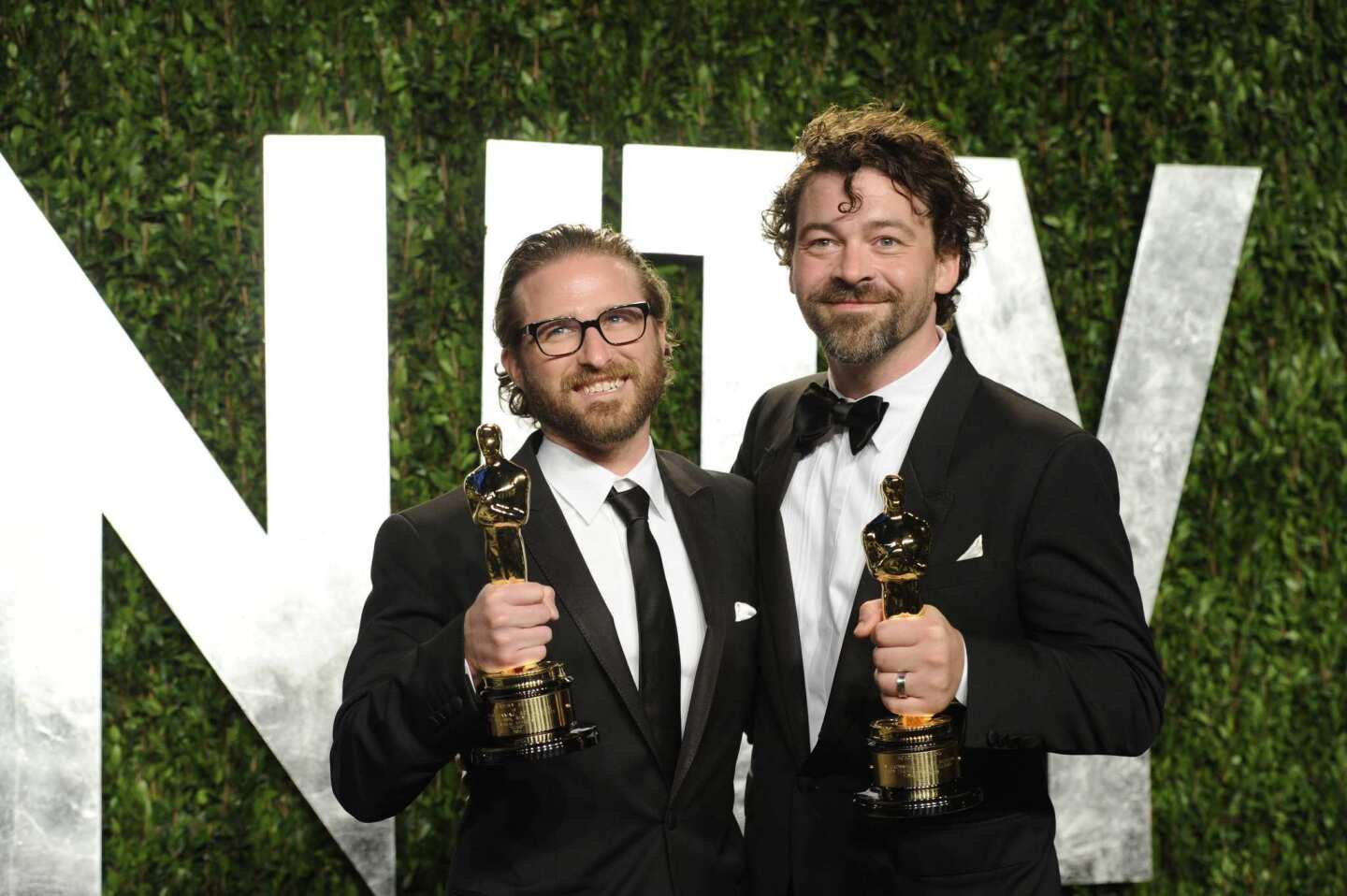 Alex Henning, left, and Ben Grossman pose with their Oscars for visual effects for "Hugo."