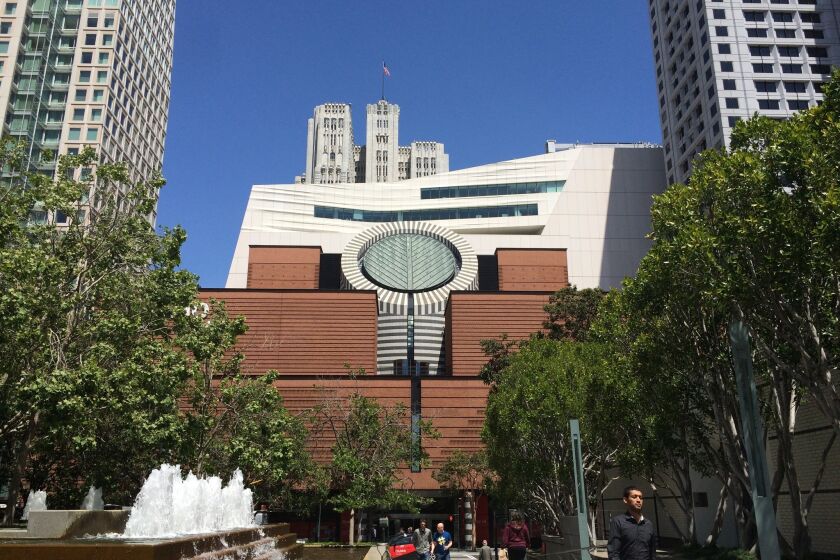 The San Francisco Museum of Modern Art reopens to the public next month with a 10-story addition designed by Snohetta. The billowing expansion peaks out from behind the building's original Mario Botta-designed structure.