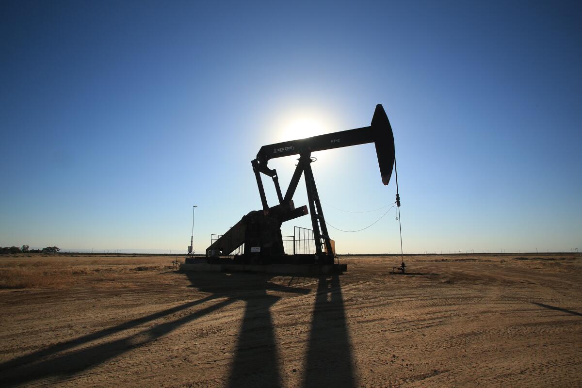 A pumpjack works in an oil field. 