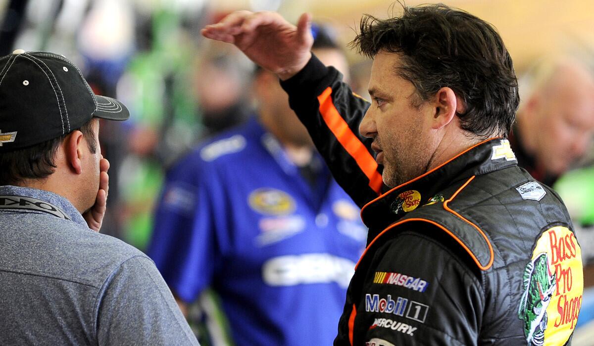 NASCAR driver Tony Stewart, right, meets with his crew during Sprint Cup Series practice on Friday at Atlanta Motor Speedway.