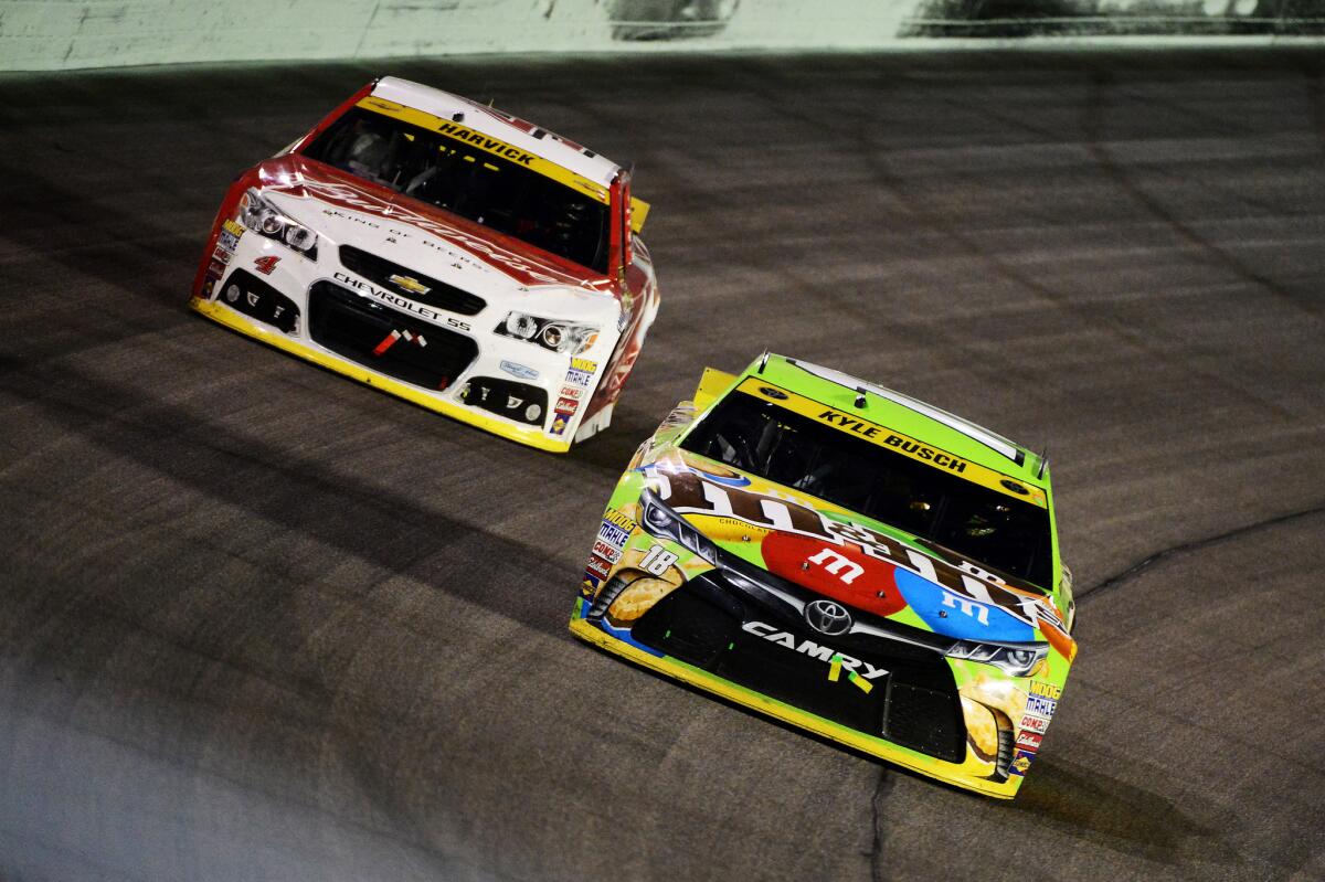 Kyle Busch, driver of the No. 18 M&M's Crispy Toyota, leads Kevin Harvick in the No. 4 Budweiser/Jimmy John's Chevrolet, during the NASCAR Sprint Cup Series Ford EcoBoost 400 at Homestead-Miami Speedway on Nov. 22.