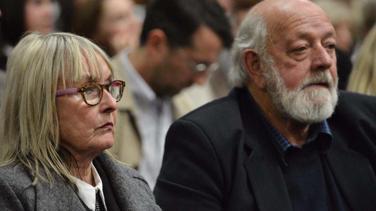 The parents of Reeva Steenkamp, June and Barry Steenkamp, stand in the court room at Pretoria High Court on June 13, 2016, during the South African Paralympian Oscar Pistorius sentencing hearing set to send him back to jail for killing his girlfriend three years agog.