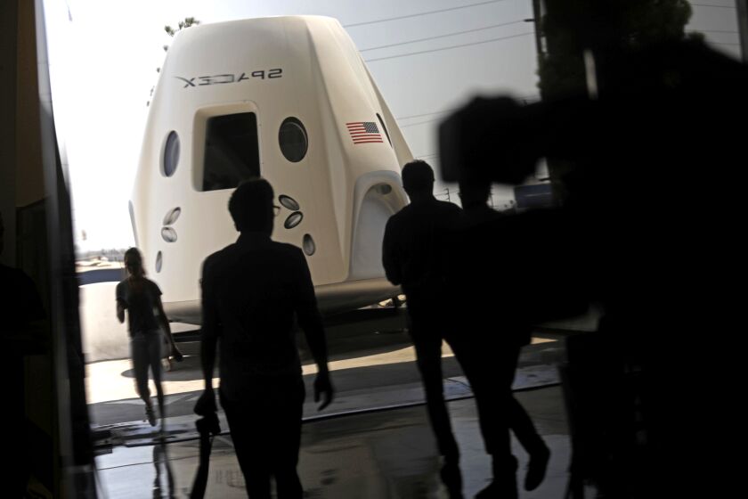 HAWTHORNE, CA - AUGUST 13, 2018 - A prototype of the Crew Dragon space craft was on display for members of the media at SpaceX in Hawthorne on August 13, 2018. This image was a reflection made in a nearby window. (Genaro Molina/Los Angeles Times)