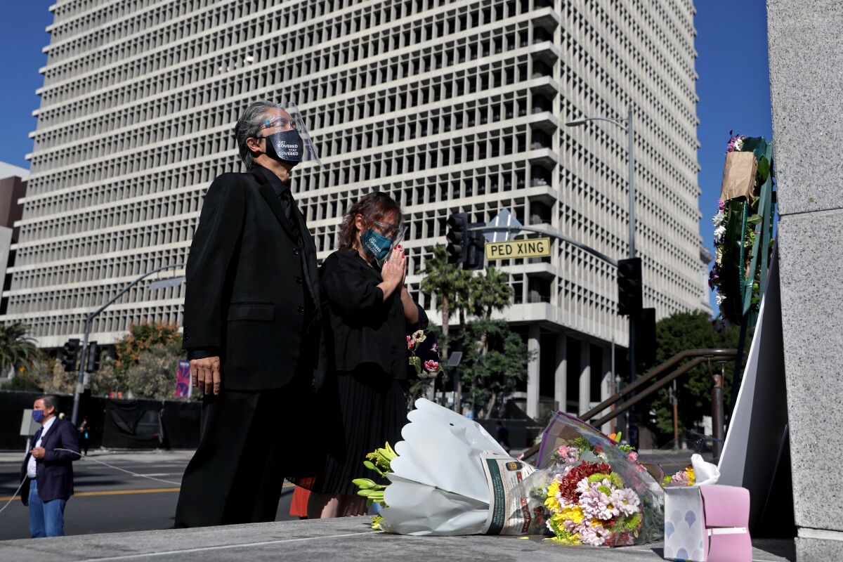 A court interpreter, left, and his significant other attend a vigil outside Los Angeles Superior Court.