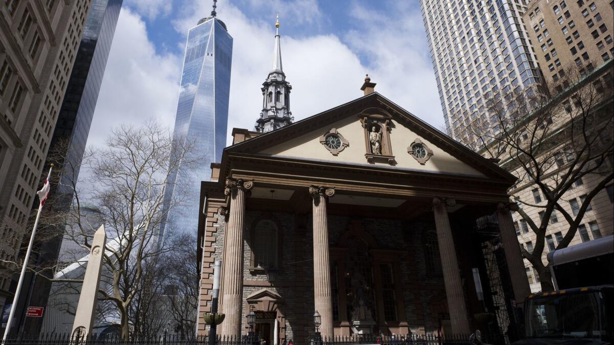In this March 16, 2018, photo, One World Trade Center towers above St. Paul's Chapel in New York., where two church that survived 9/11 have installed metal detectors.