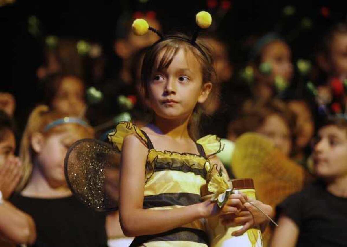 Chloe Chan, 6, performs onstage during their Bugz! performance, which took place at Hoover High School's auditorium in Glendale. About 320 students from the Mark Keppel Visual and Performing Arts Magnet school participated in the performance.