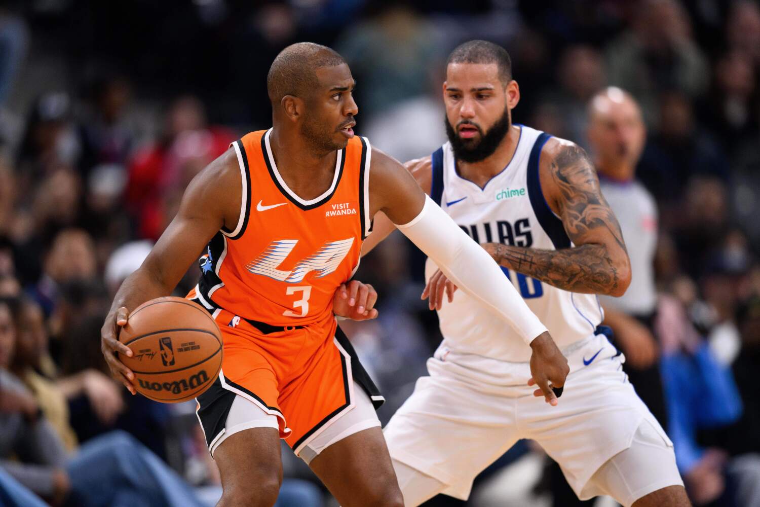 Clippers guard Chris Paul controls the ball under pressure from Mavericks forward Caleb Martin on Saturday.