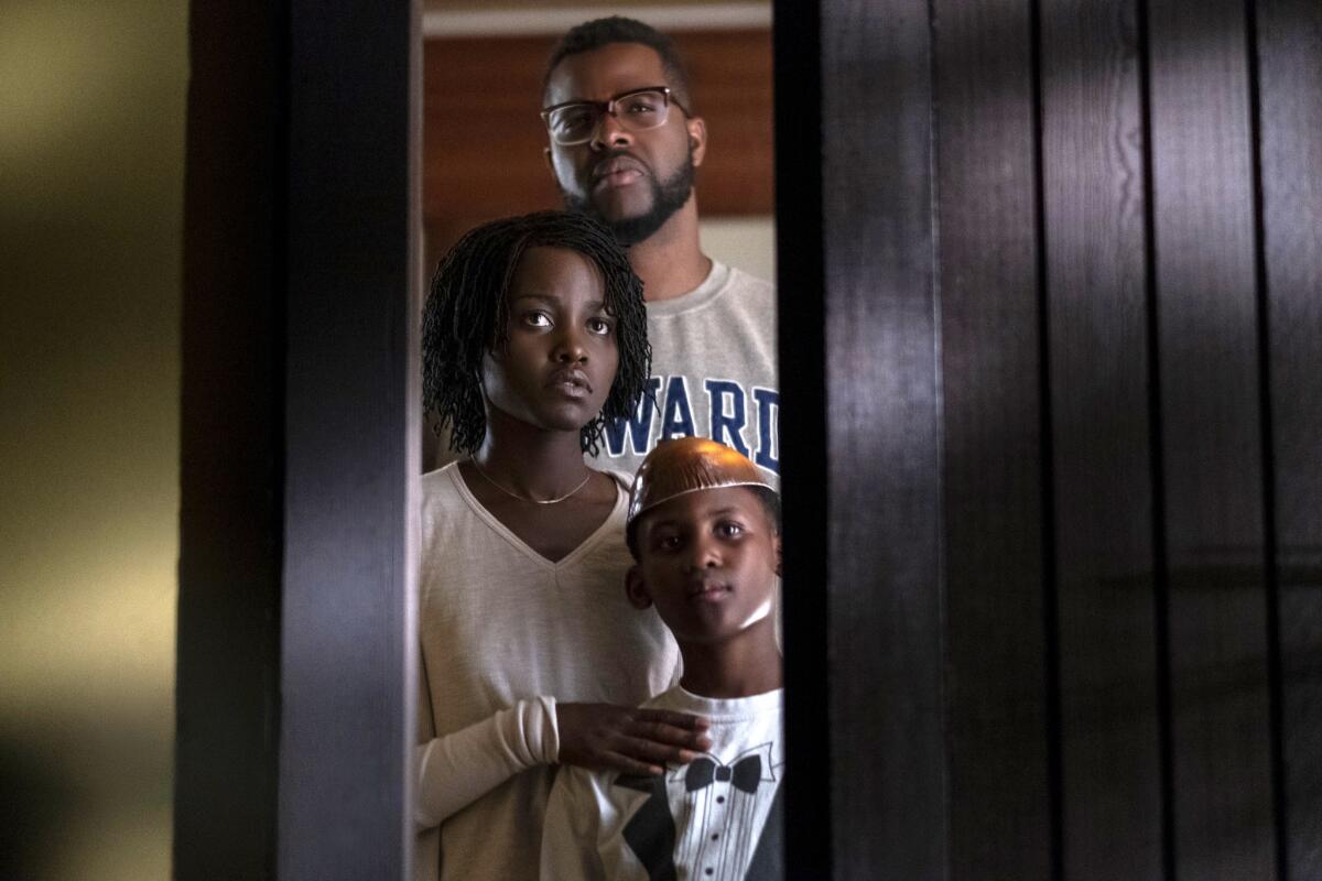 A Black family waits at the front door for trouble.