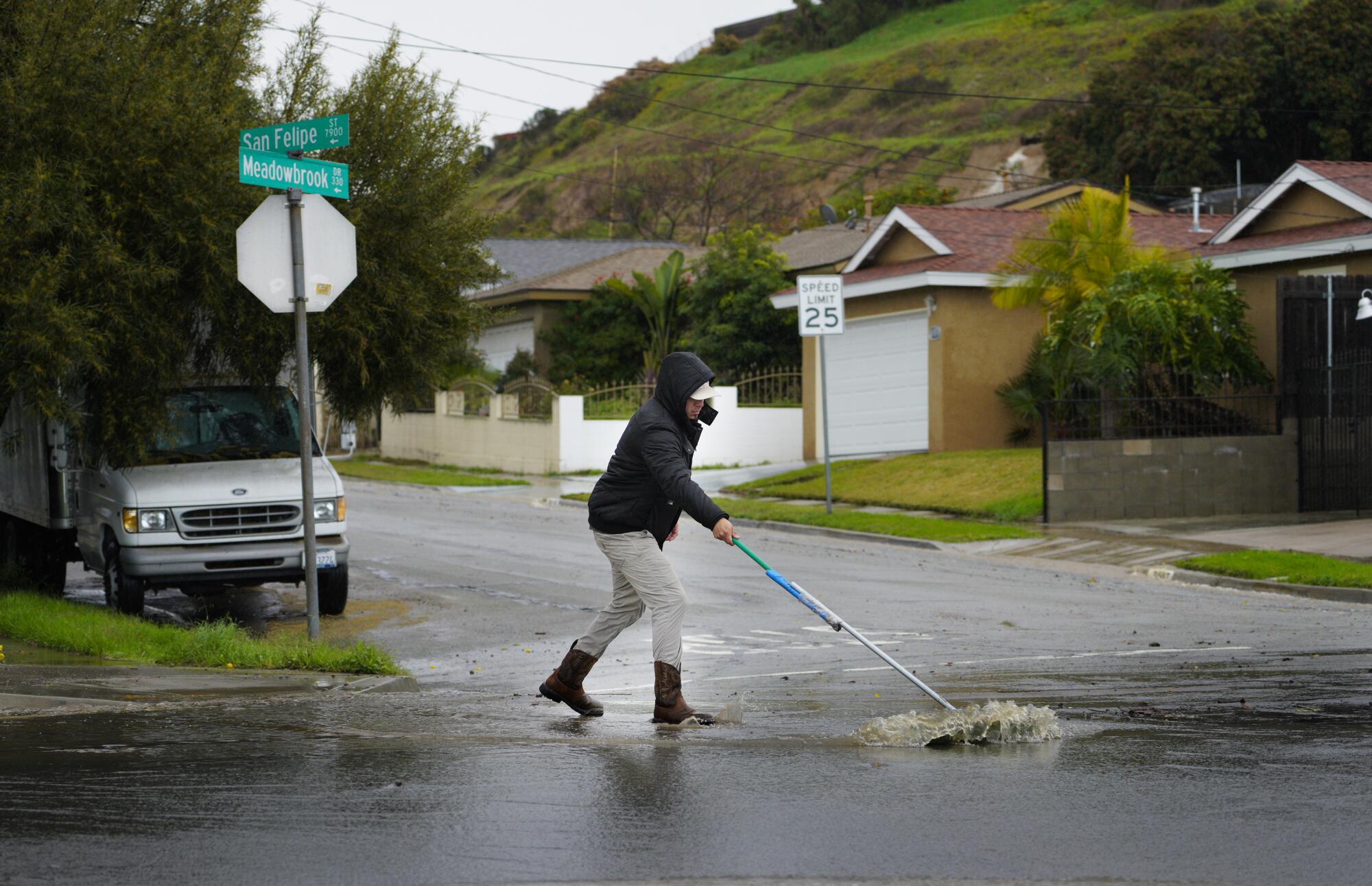One man used a broom to help drain excess water.