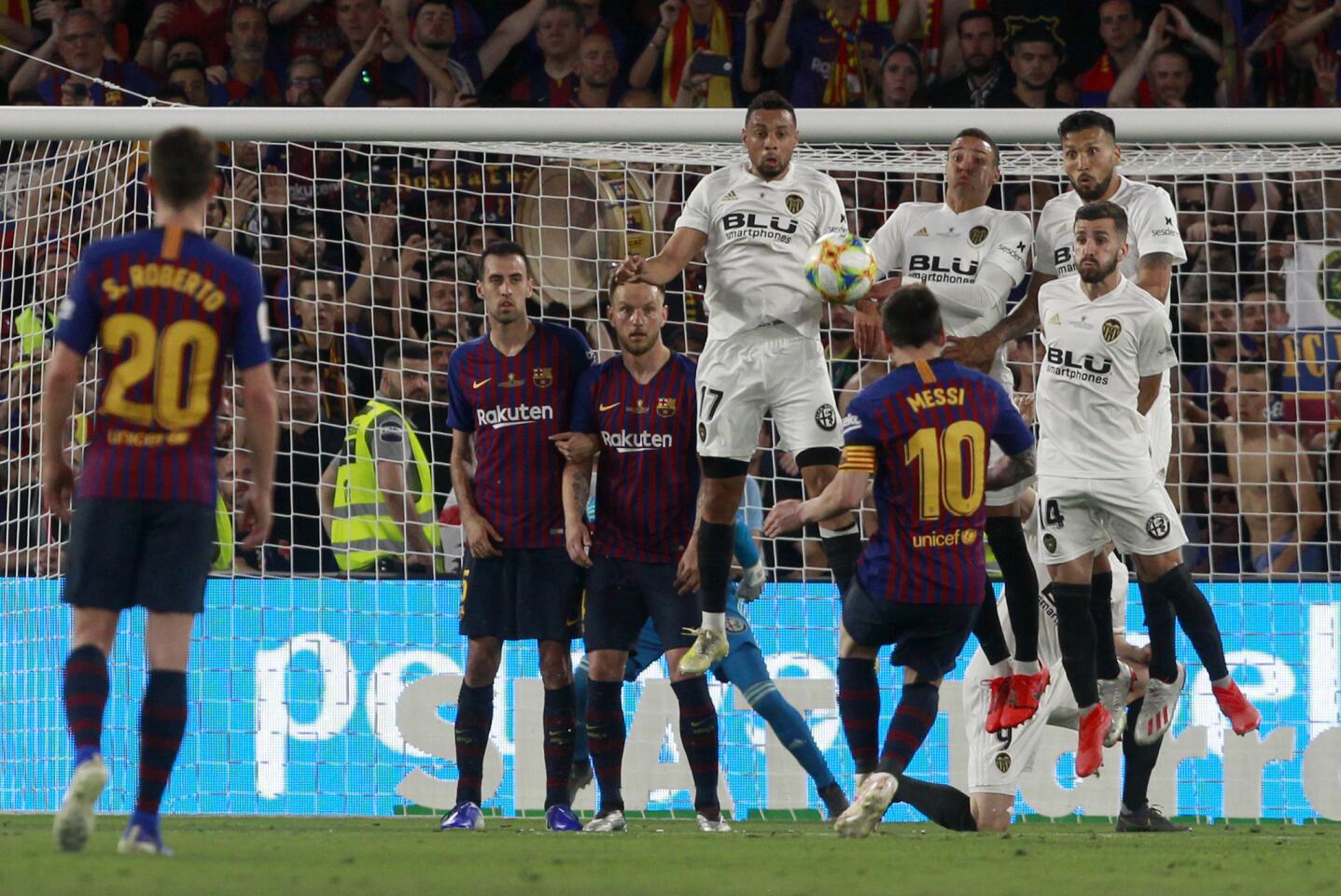 Barcelona forward Lionel Messi takes a free kick during the Copa del Rey soccer match final between Valencia CF and FC Barcelona at the Benito Villamarin stadium in Seville, Spain, Saturday. 25, 2019.