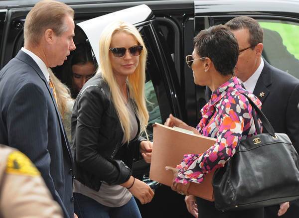 Lindsay Lohan arrives with her lawyer Shawn Chapman Holly (R) to begin her 90 day jail sentence at the Beverly Hills Courthouse on July 20, 2010.