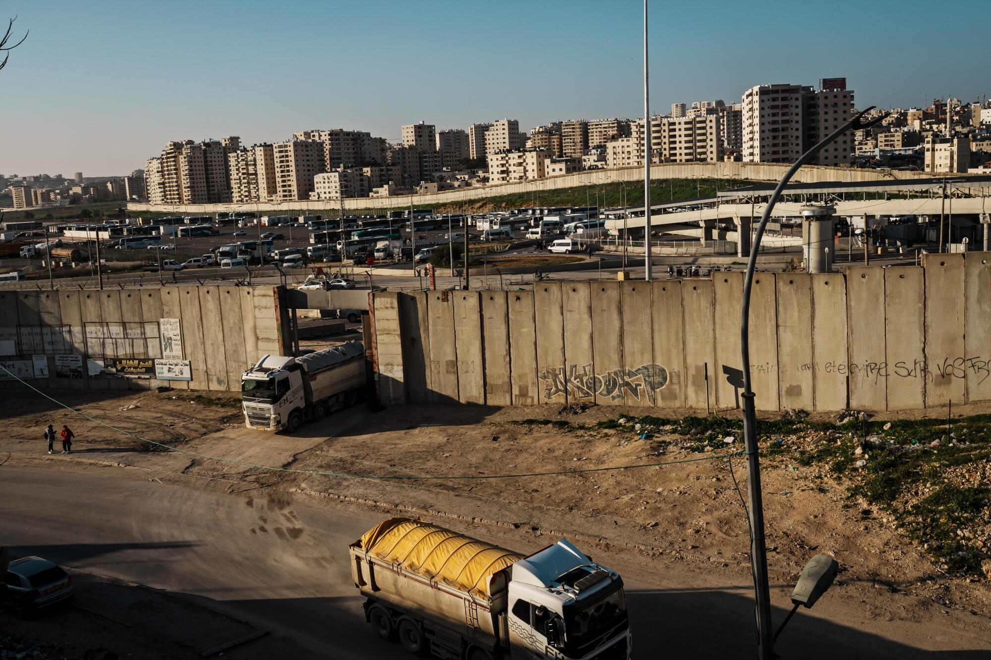 Commercial trucks travel during rush hour on Highway 60 near the Qalandiya checkpoint.