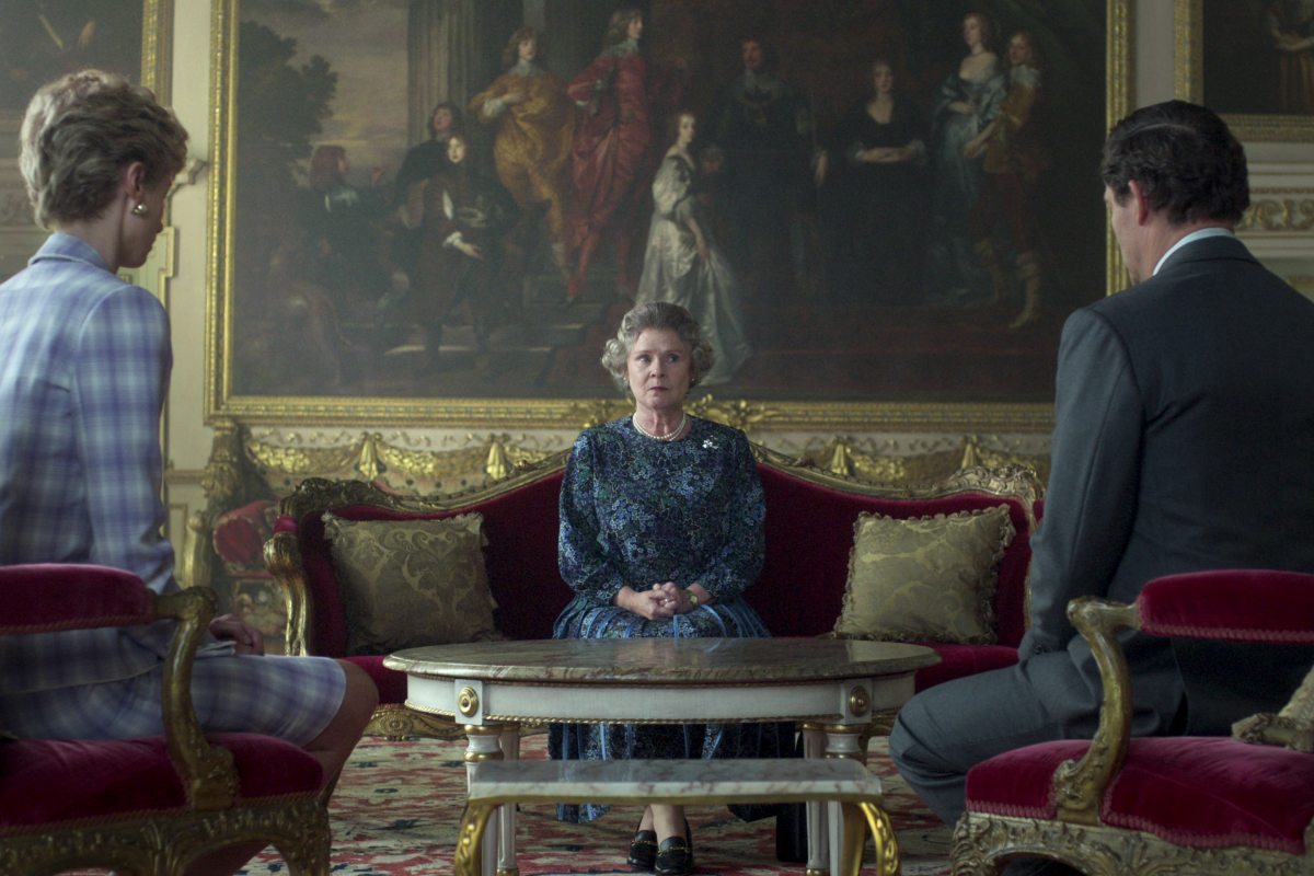 An older woman is flanked by a woman and man in "The Crown."