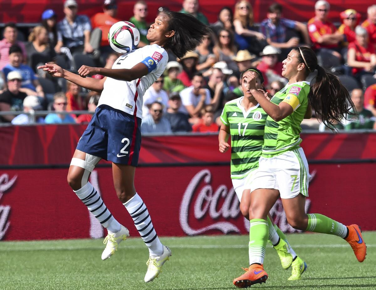 France's Wendie Renard, left, controls the ball in front of Mexico's Nayeli Rangel during their Group F match Wednesday at the Women's World Cup in Ottawa, Canada.