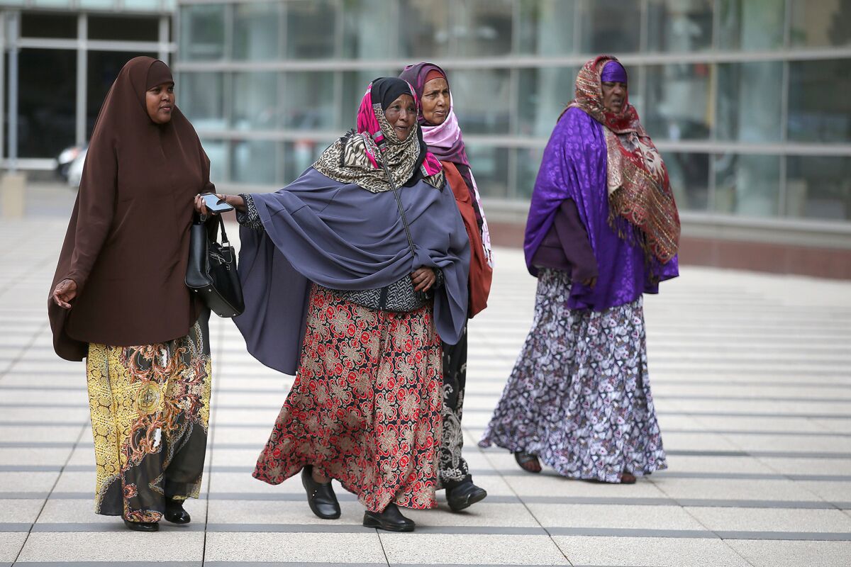 Family members of the three men facing terrorism-related charges make their way to the courthouse in Minneapolis.
