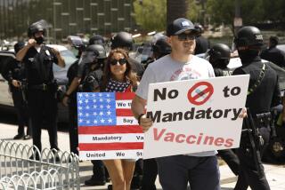 LOS ANGELES, CA - AUGUST 14, 2021 - - Advocates against vaccine mandates protest in front of City Hall in downtown Los Angeles on August 14, 2021. (Genaro Molina / Los Angeles Times)