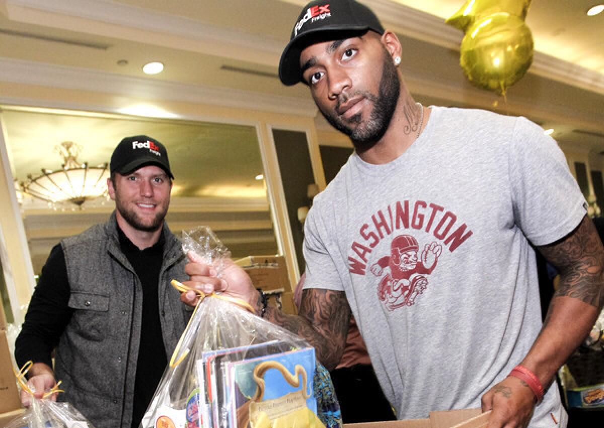 Redskins cornerback DeAngelo Hall, right, and Buccaneers safety Brian Leonard help prepare Super Baskets of Hope during a volunteer event last month in Rutherford, N.J.