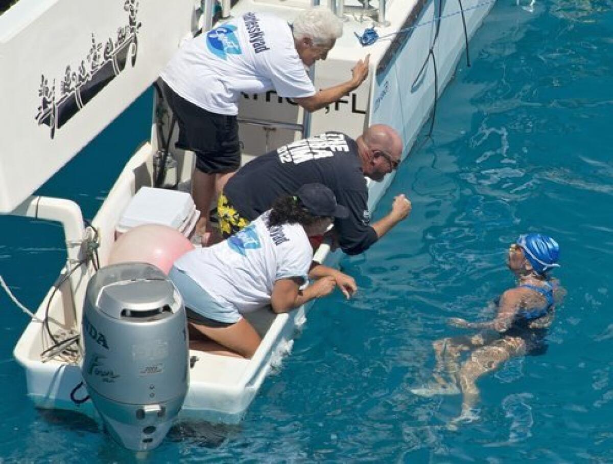 Diana Nyad talks with her crew less than two miles off Key West, Fla.
