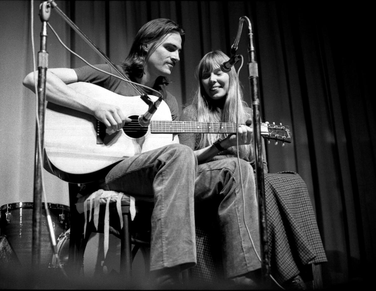 James Taylor and Joni Mitchell perform circa 1970