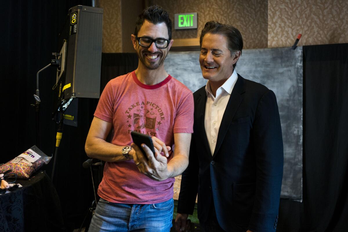 Los Angeles Times photographer Jay L. Clendenin and actor Kyle MacLachlan laugh at the final cut.