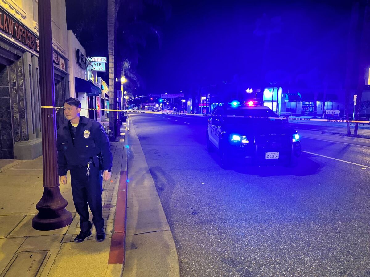 A law enforcement officer on a sidewalk.