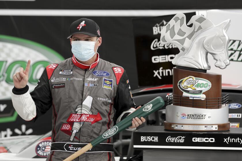 Cole Custer celebrates with the trophy after winning a NASCAR Cup Series auto race Sunday, July 12, 2020, in Sparta, Ky. (AP Photo/Mark Humphrey)