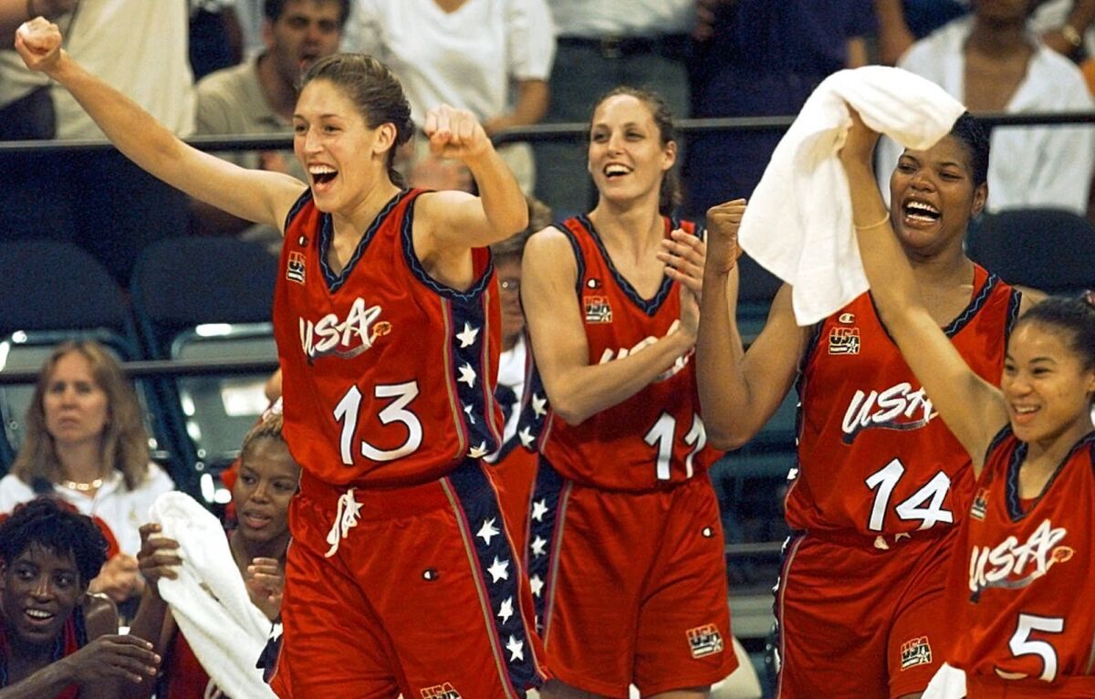 FILE - In this July 27, 1996, file photo, USA's Rebecca Lobo (13) leads the team off the bench to cheer at the end of their 96-79 victory over Australia in women's Olympic basketball at the Georgia Dome in Atlanta. From left are Lobo, Katy Steding (11), Venus Lacey (14), and Dawn Staley (5). (AP Photo/Elise Amendola, File)