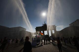 Police spray water canon at the Brandenburg Gate during a heat wave in Berlin, in June.