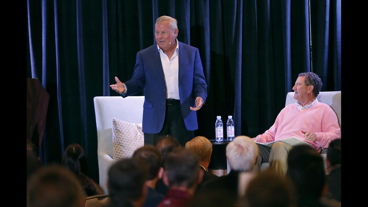 Guest of honor Lanny Wadkins, left, 21-time PGA TOUR winner and World Golf Hall of Famer, is welcomed to the stage with Hank Adler, right, Chairman Emeritus Toshiba Classic, during Toshiba Classicâ€™s Breakfast with a Champion event at Balboa Bay Resort on Tuesday.