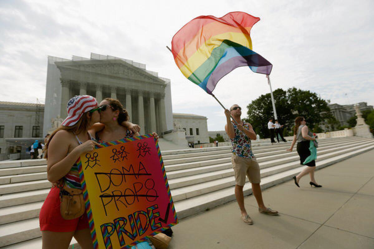 Meghan Cleary, left, and Sarah Beth Alcabes from Berkeley, Calif., show their support for gay rights in front of the Supreme Court building in Washington.
