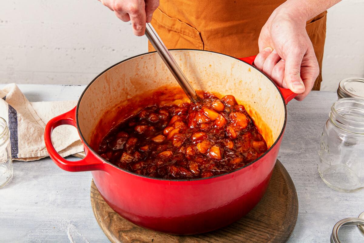 A mixture of chopped stone fruit in a pot.