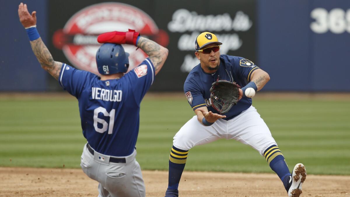 The Dodgers' Alex Verdugo is forced out at second base by Milwaukee Brewers shortstop Hernan Perez on a ball hit by Ezequiel Carrera during the second inning.