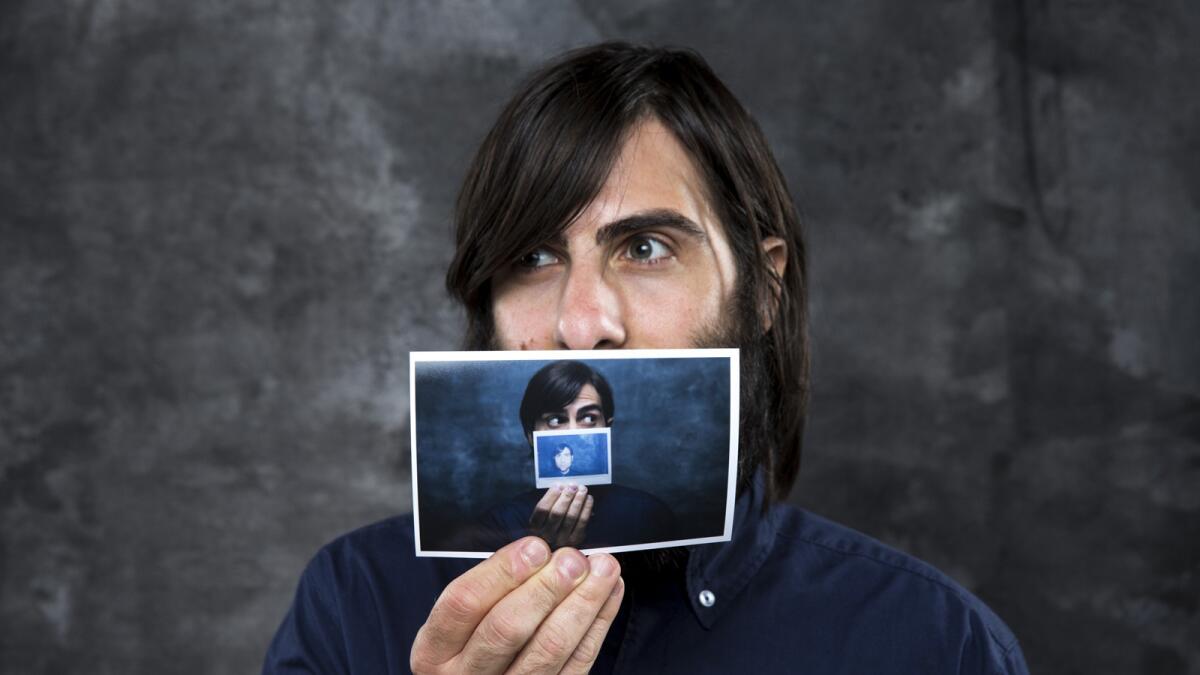 Actor Jason Schwartzman, from the new film, "The Overnight," is photographed holding a picture of himself before taking part in a panel discussion at the L.A. Times Indie Focus screening of his film.