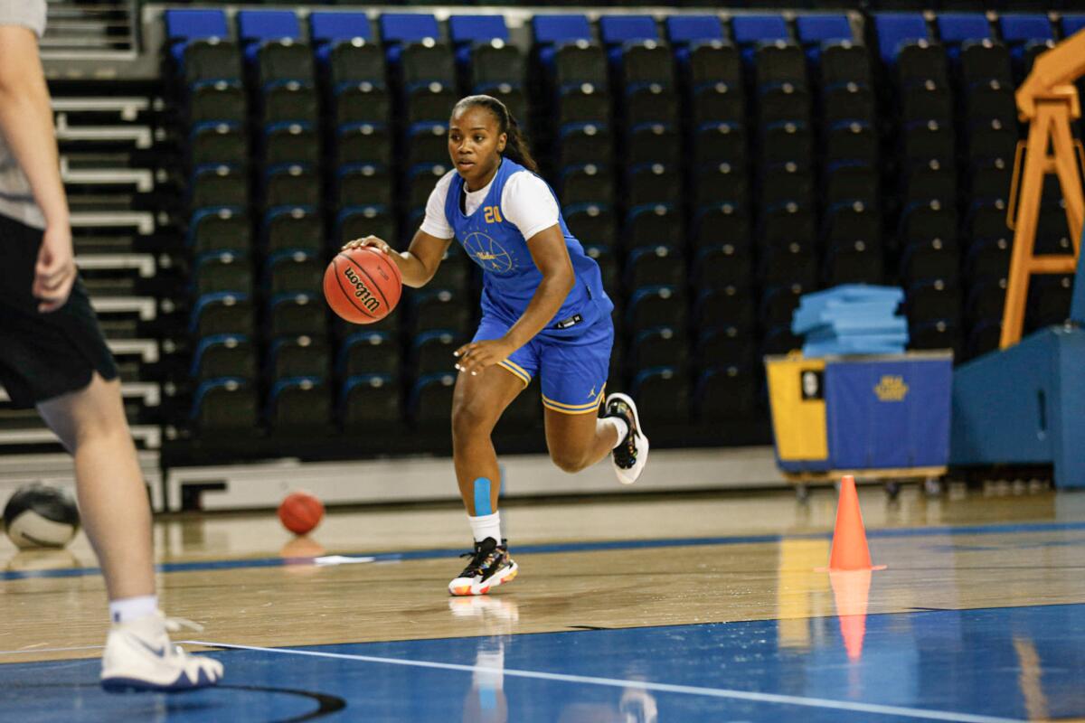 Charisma Osborne dribbles during a UCLA basketball practice.