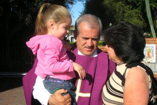 Father Francisco Valdovinos, shown here with parishioners, died last January of COVID-19 at 58.