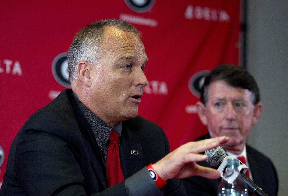 Georgia Coach Mark Richt speaks as Athletic Director Greg McGarity looks on during a news conference to discuss Richt's departure from the school.