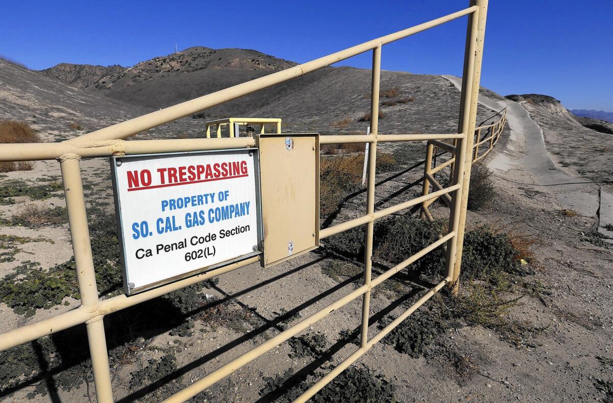 A sign on a metal gate says No Trespassing, Property of SoCal Gas Company