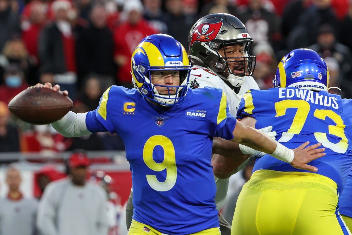 Rams quarterback Matthew Stafford avoid Buccaneers pressure in the pocket.