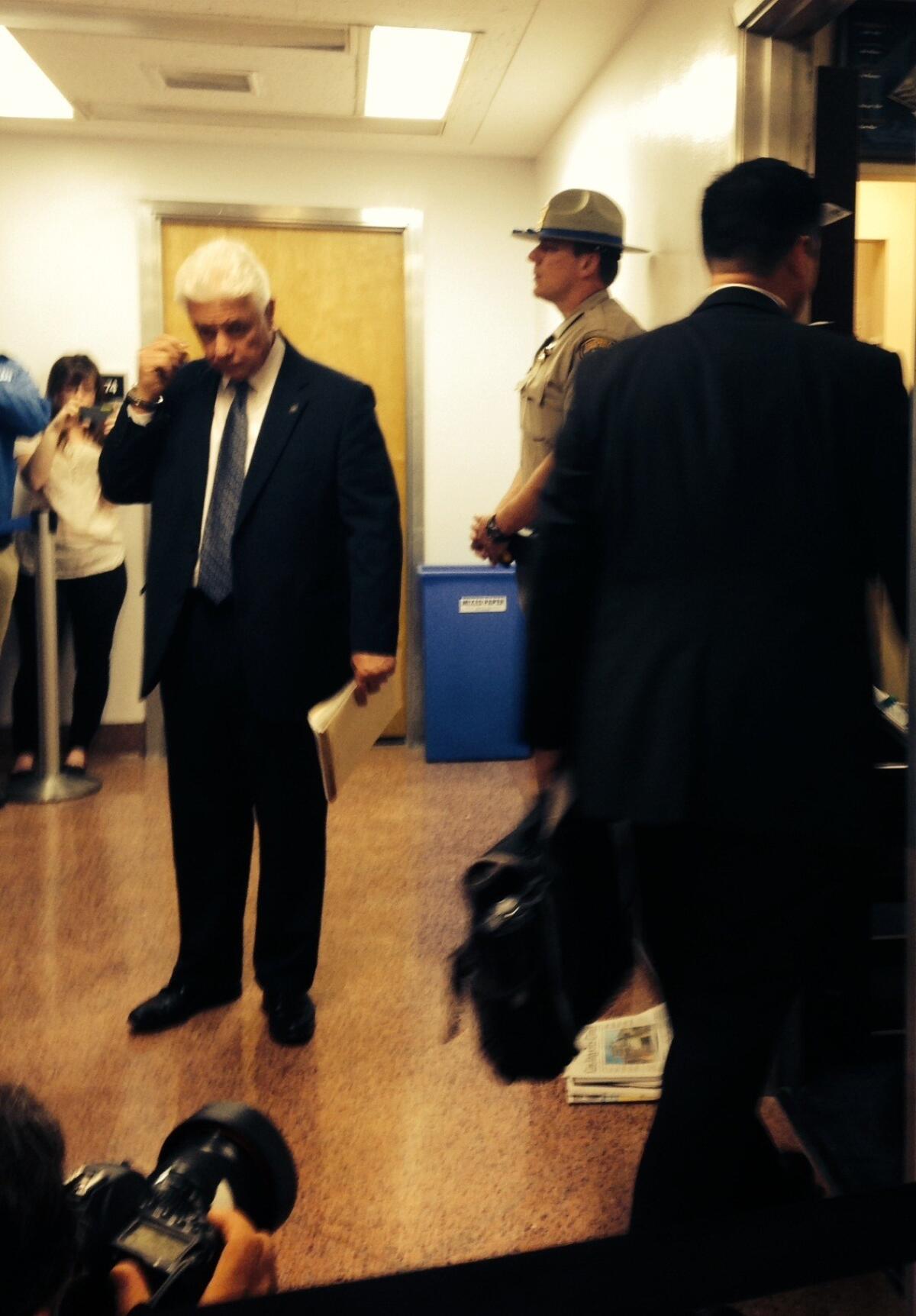 Senate Sergeant at Arms Tony Beard, left, stands by as a federal agent enters the Capitol office of Sen. Leland Yee (D-San Francisco), who was arrested Wednesday morning.