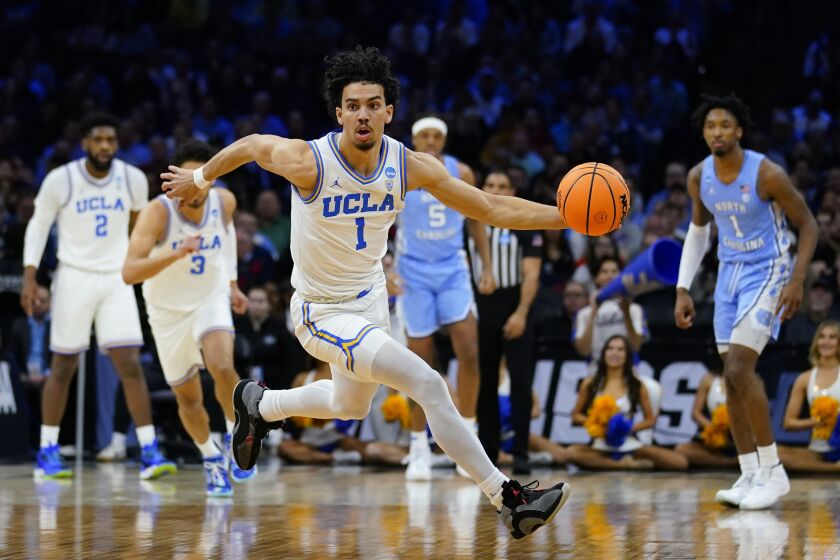 UCLA's Jules Bernard dribbles during the first half of a college basketball game against North Carolina.
