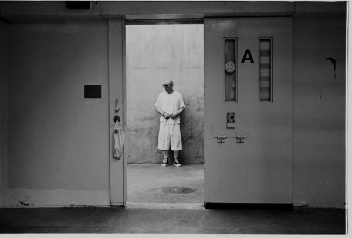 An inmate stands in the concrete exercise area of his solitary confinement unit at Pelican Bay State Prison.