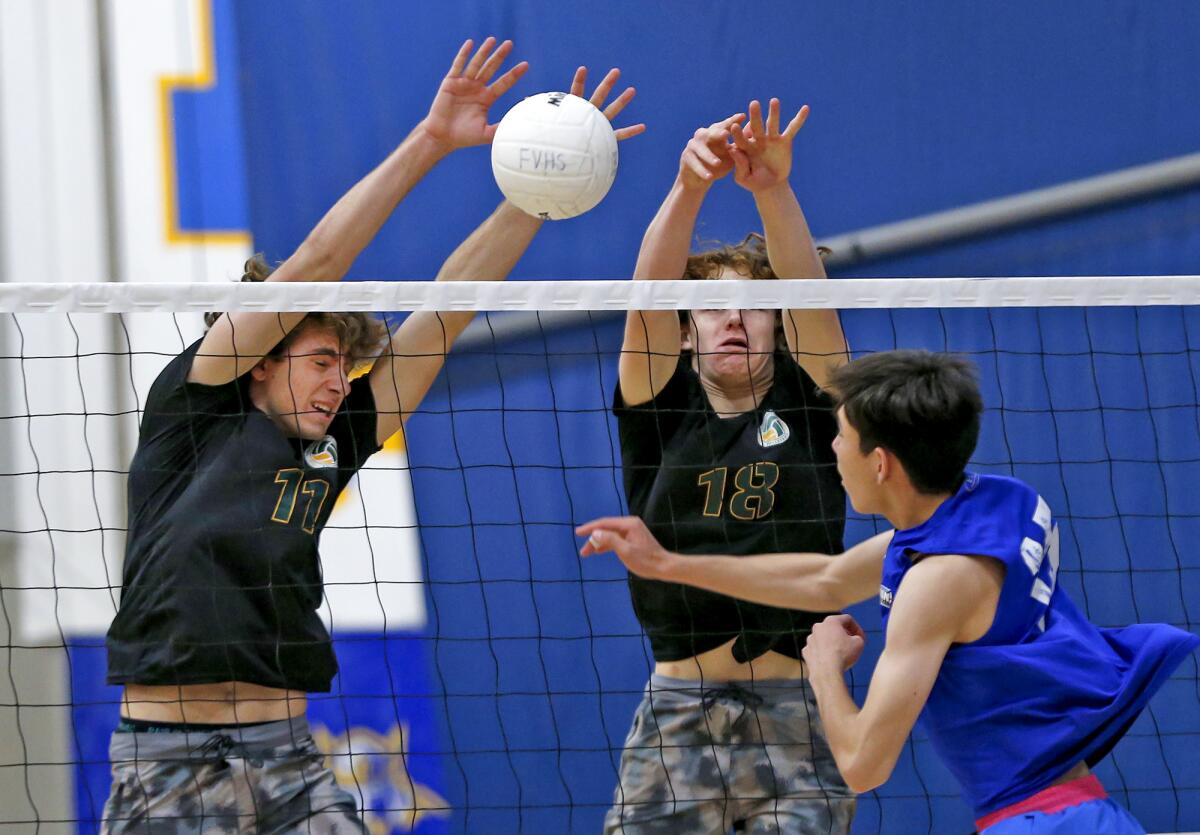Edison's Emerson Evans (11) and Owen Banner (18) block a ball from Fountain Valley's Bennett Heydorn (15) on Friday.